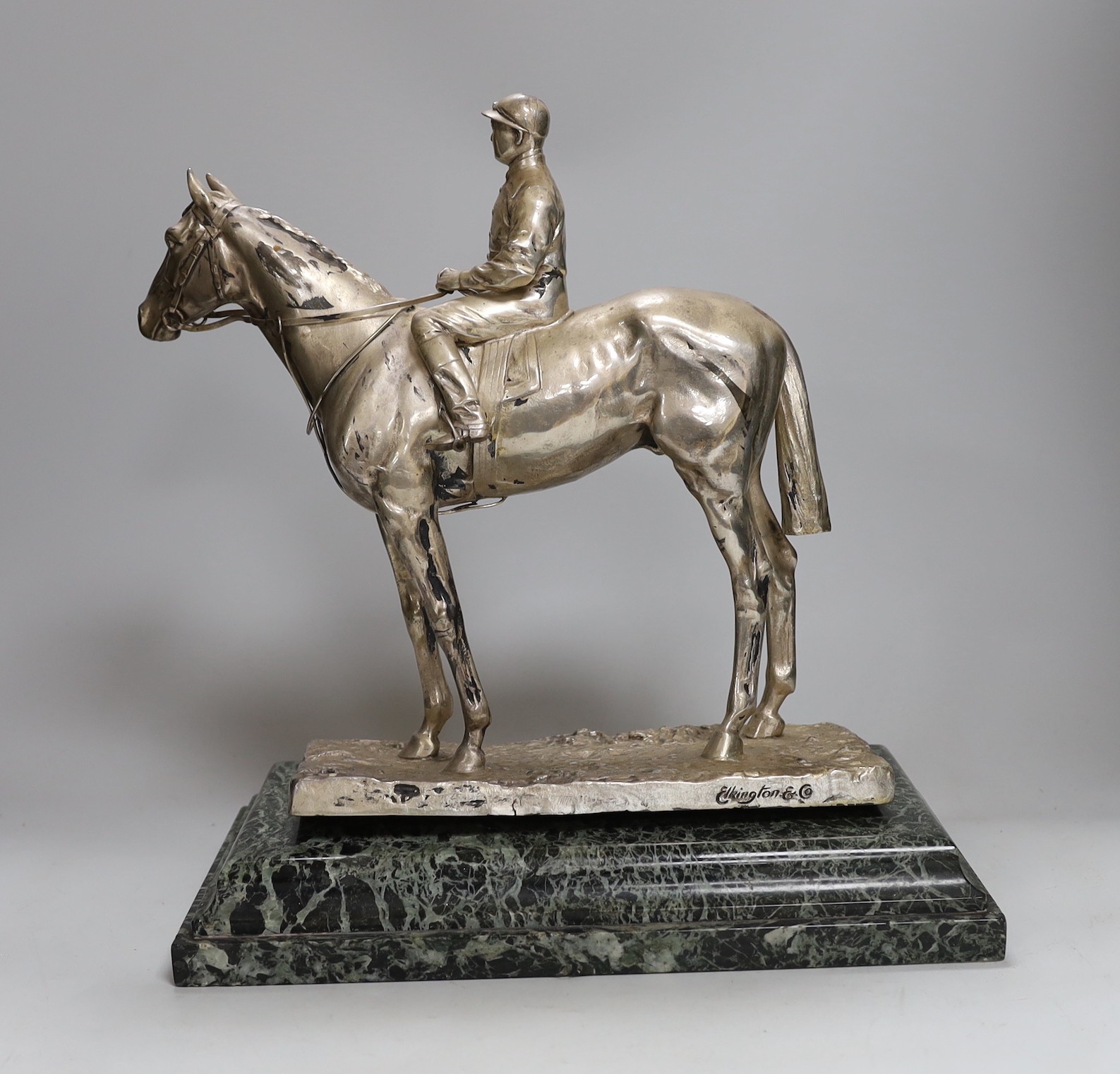 A Elkington & Co. silver plated model of a horse and jockey, on marble base, 34cms high